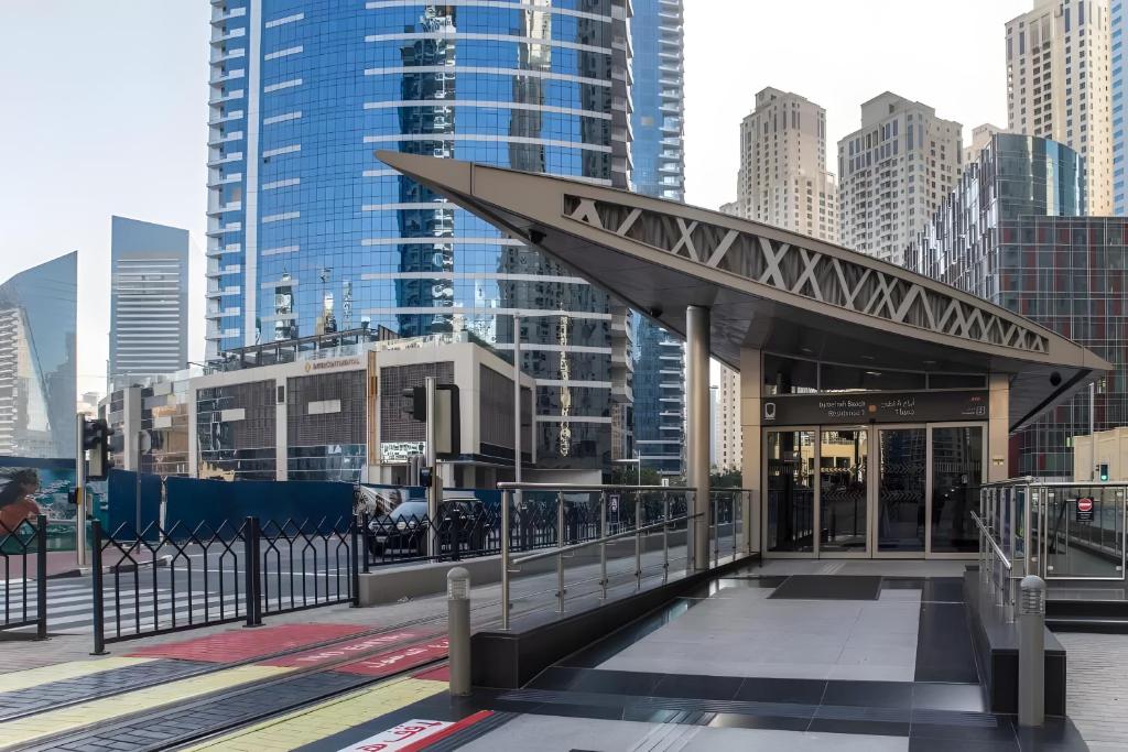 a building with awning in a city with tall buildings at InterContinental Dubai Marina by IHG in Dubai