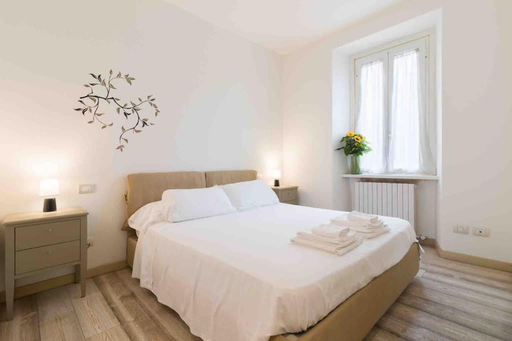 a bedroom with a white bed with towels on it at Splendido Appartamento con 2 camere da letto in Milan