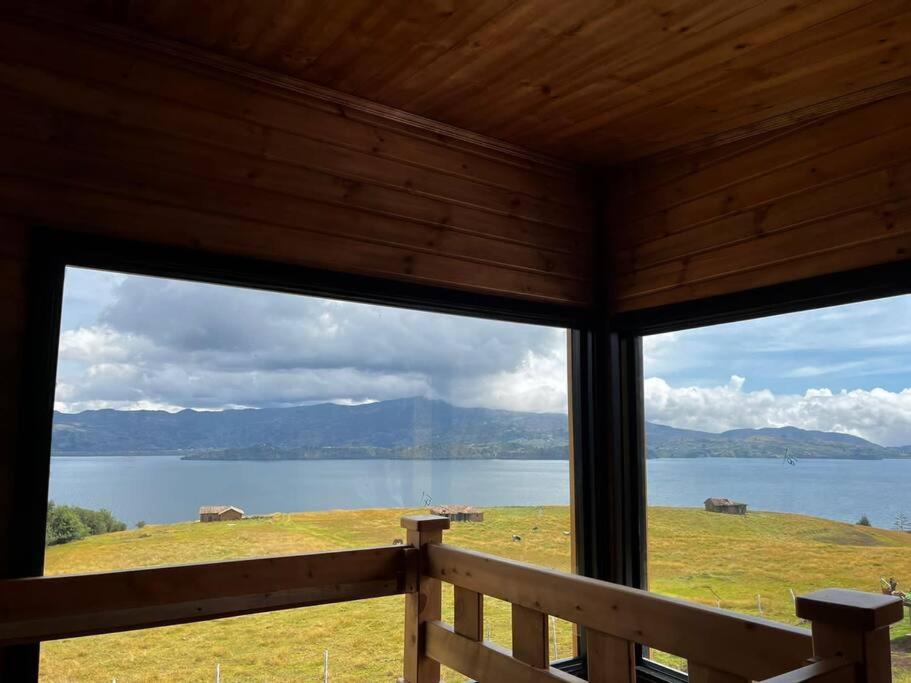 a view of a lake from the inside of a cabin at Villa San Jerónimo in Tota