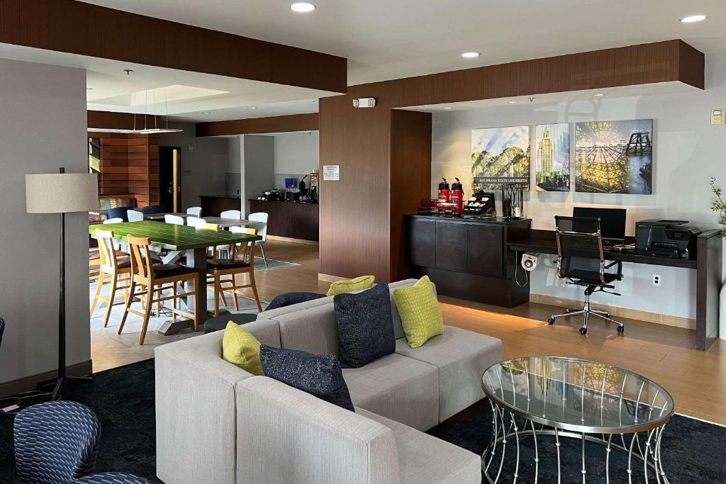 a living room with a couch and a table at Baton Rouge Inn & Suites LSU-Medical Corridor in Baton Rouge