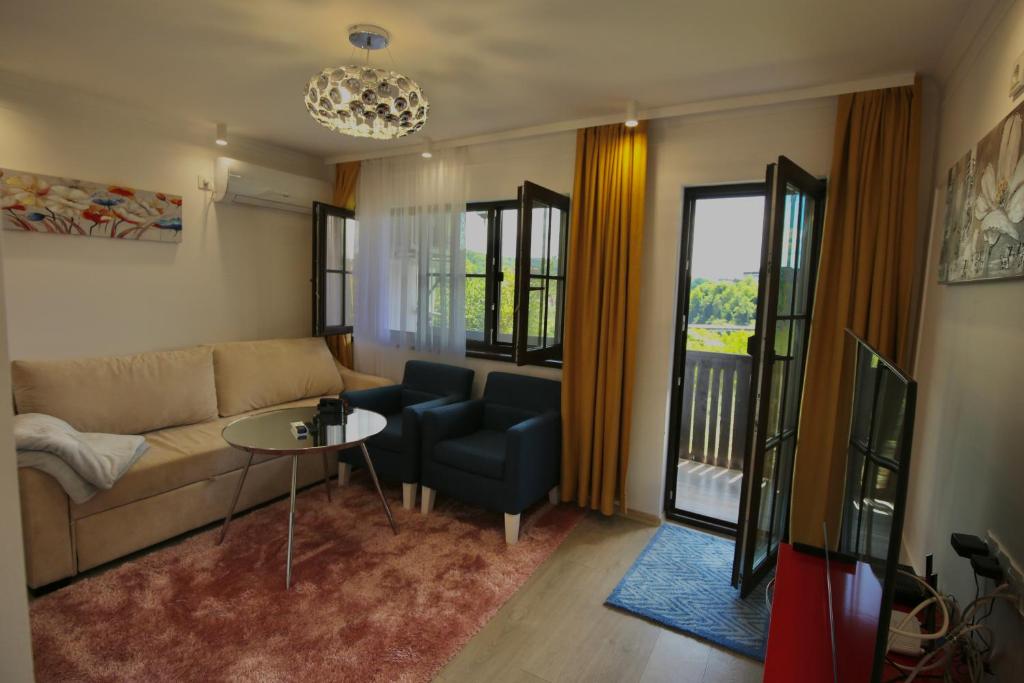 a living room with a couch and a table at Apartments Panorama in Veliko Tŭrnovo