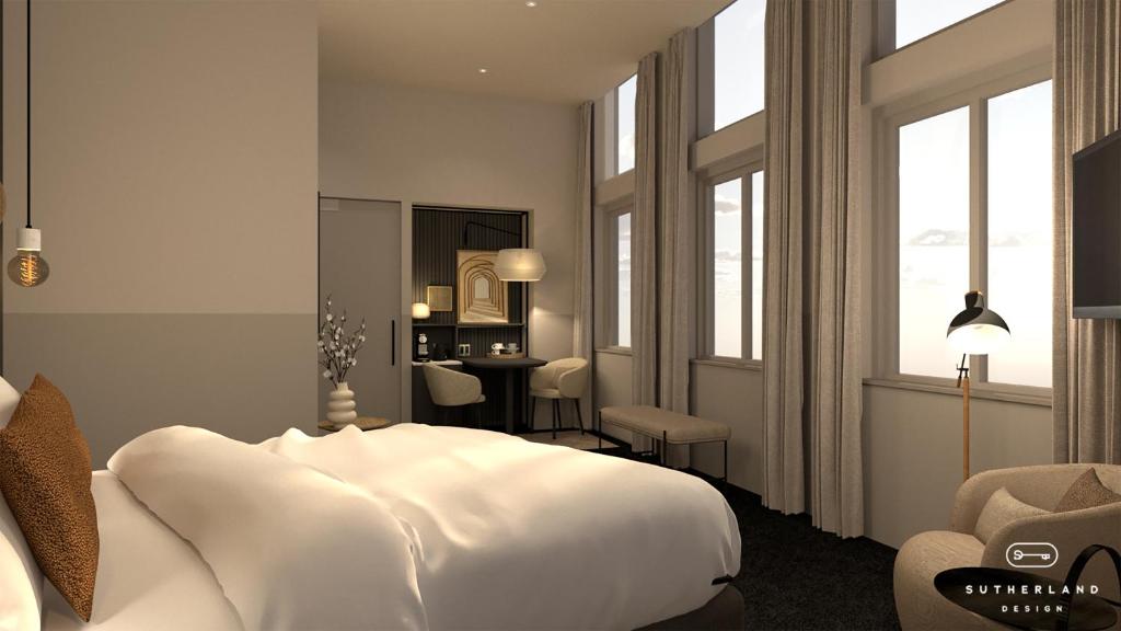 a bedroom with a large white bed and a desk at Golden Tulip Keyser Breda Centre in Breda