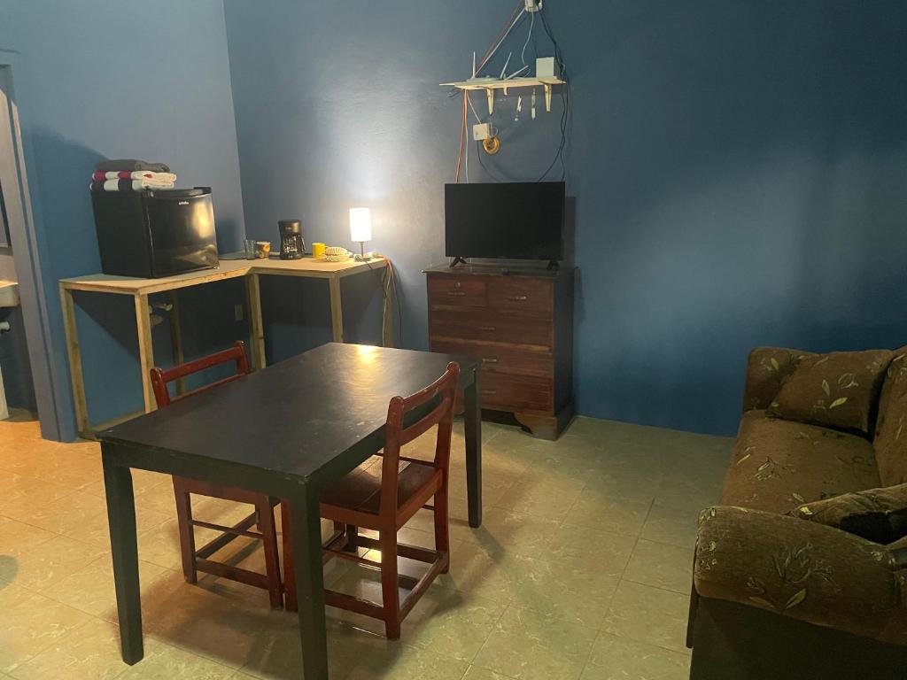 a living room with a table and a couch at Airport Inn Roatan in Coxen Hole