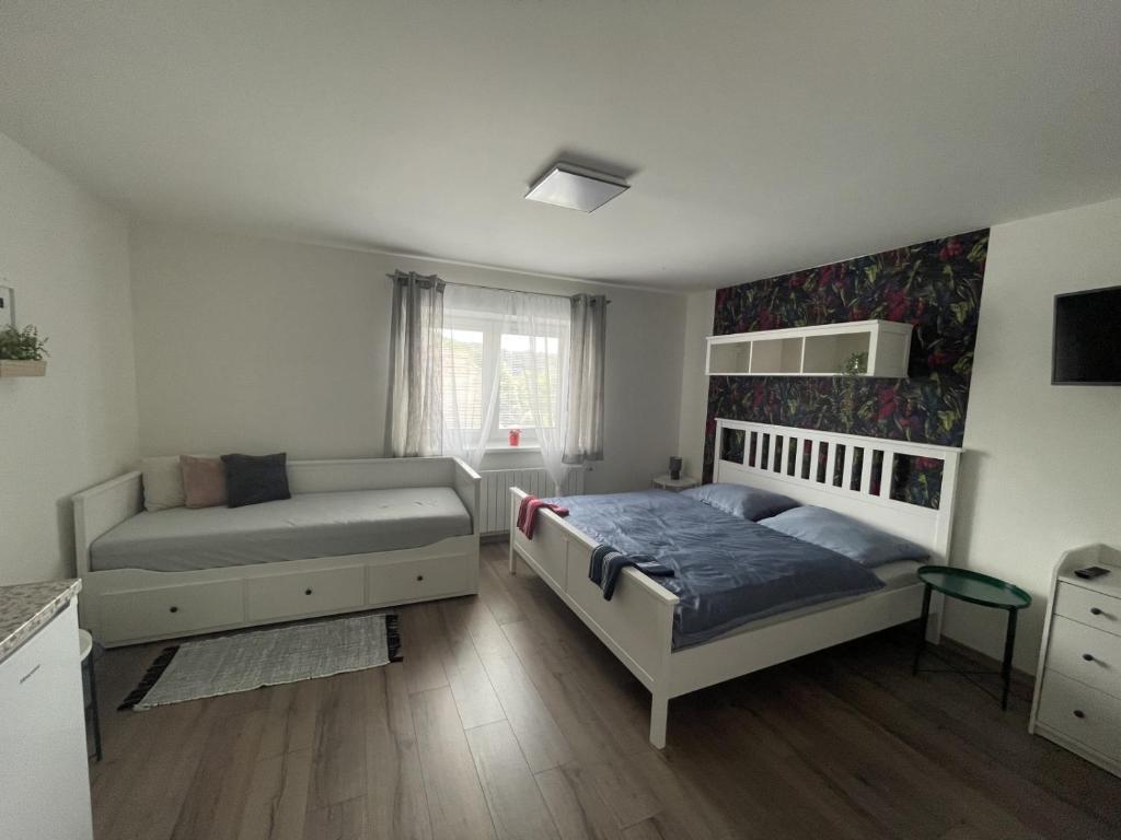 Postel nebo postele na pokoji v ubytování Apartmány Prostřední