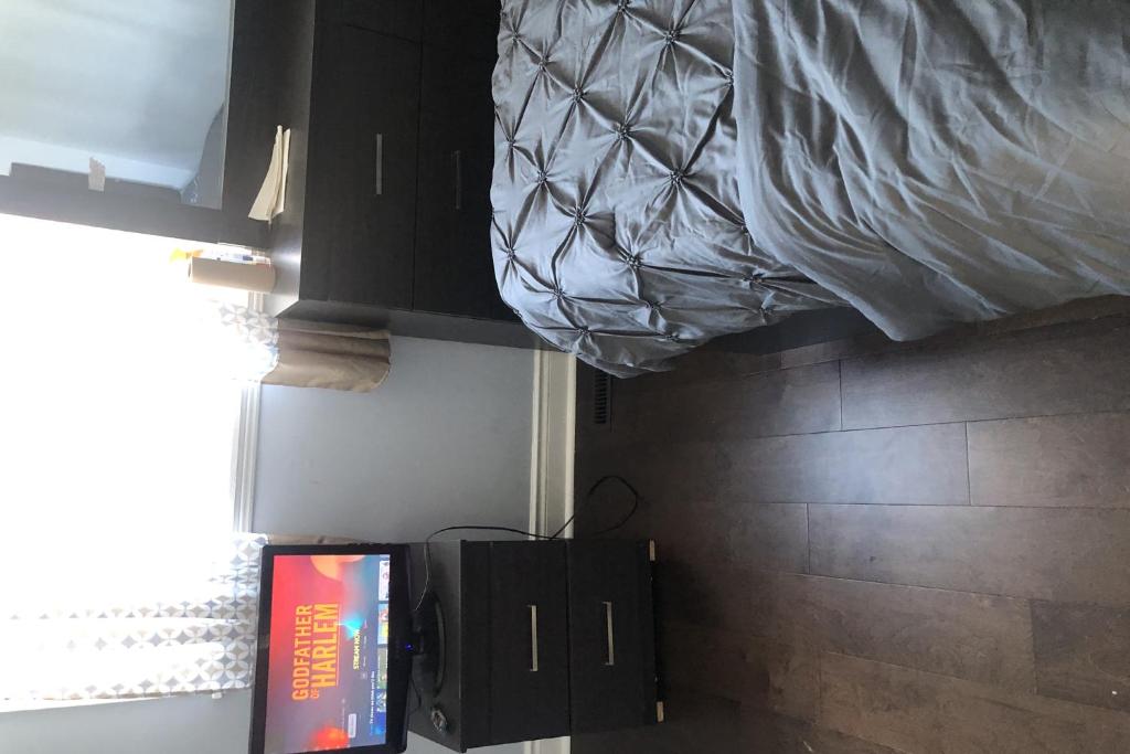 a bedroom with a bed and a television in a room at Cozy Super Delux-Shay-201 in Pickering