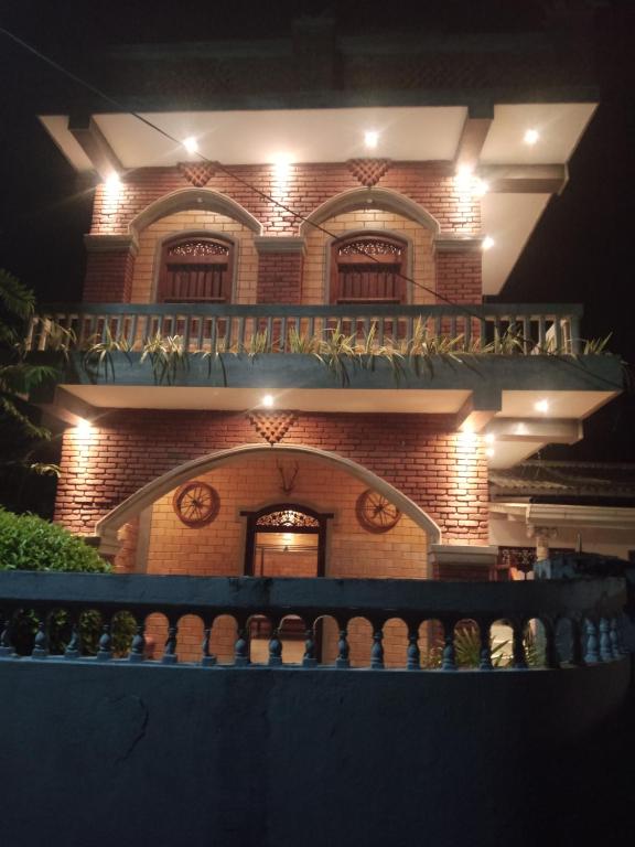 a brick building with a balcony at night at The Brick Wonder in Habaraduwa Central