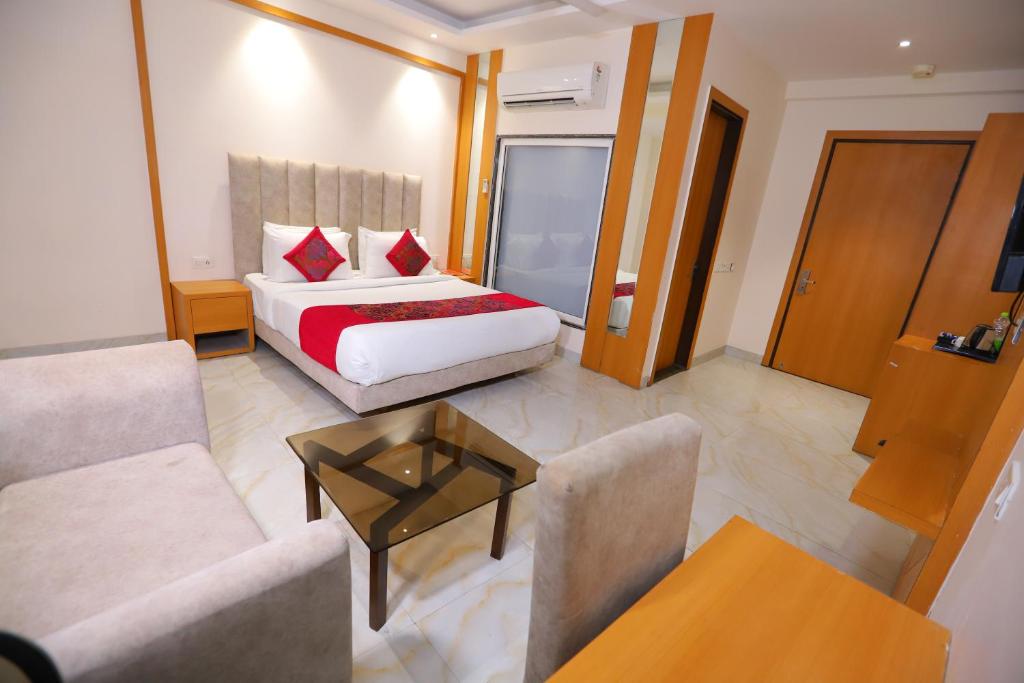 a hotel room with a bed and a couch at Hotel Stanley- Near Delhi Airport in New Delhi