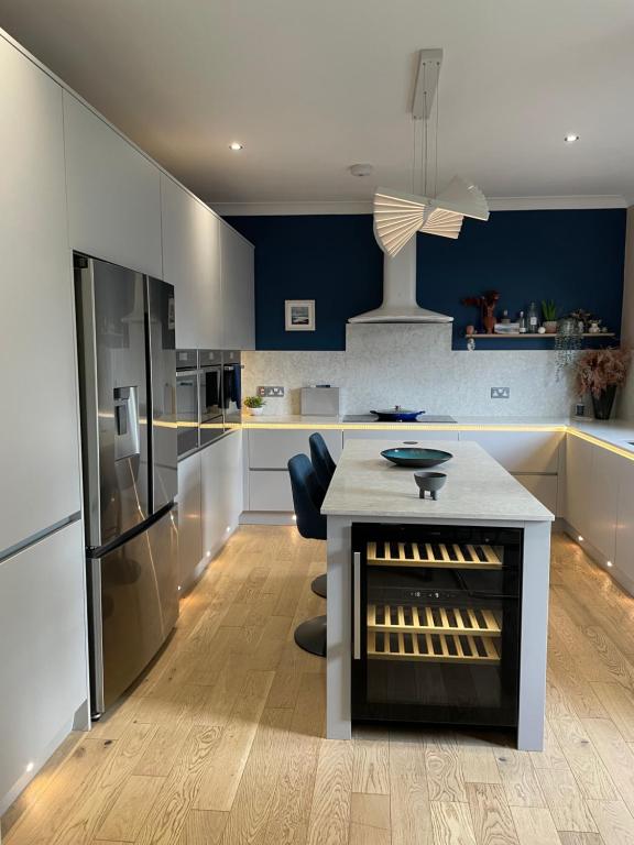 a kitchen with a table and a refrigerator at Ultra Stylish furnished Home in Edinburgh in Edinburgh