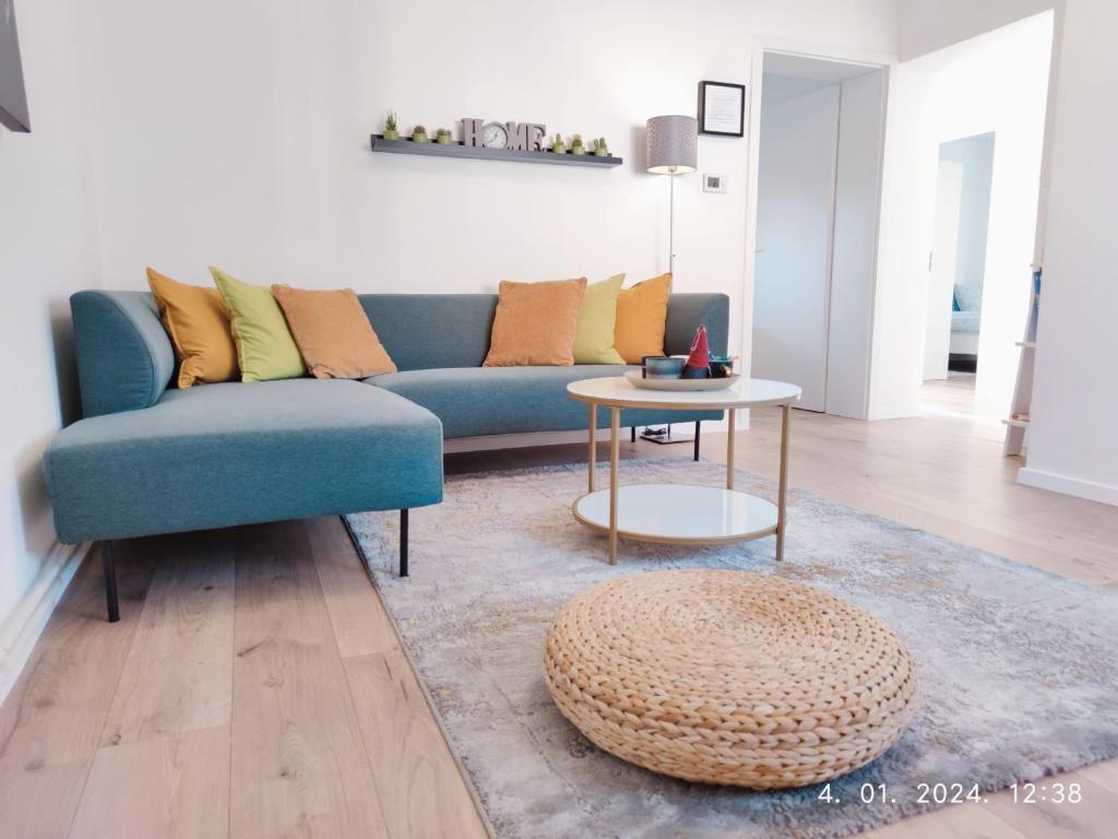 a living room with a blue couch and a table at Lumani Apartment Zagreb with FREE Parking in Zagreb