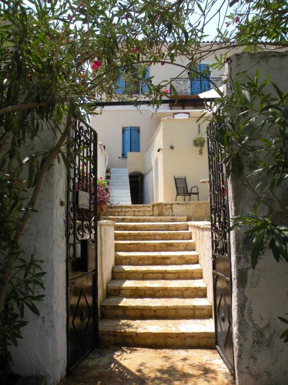 a set of stairs leading up to a building with a gate at Sea House in Galaxidi