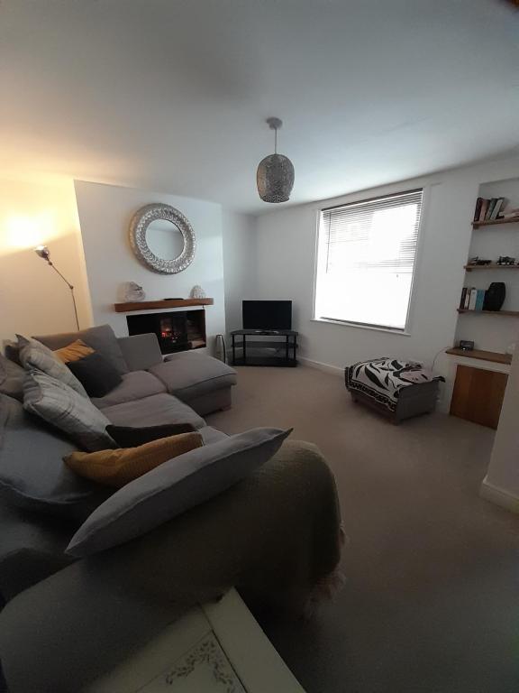 a living room with a couch and a fireplace at No. 6 The High Street in Royal Wootton Bassett
