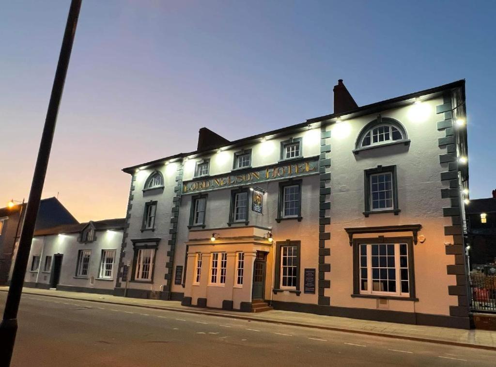 a building on a street with lights on it at THE LORD NELSON HOTEL in Pembrokeshire