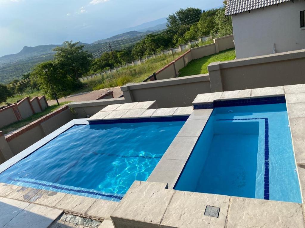 a large blue swimming pool on top of a house at The Lonely Mountain in Mataffin