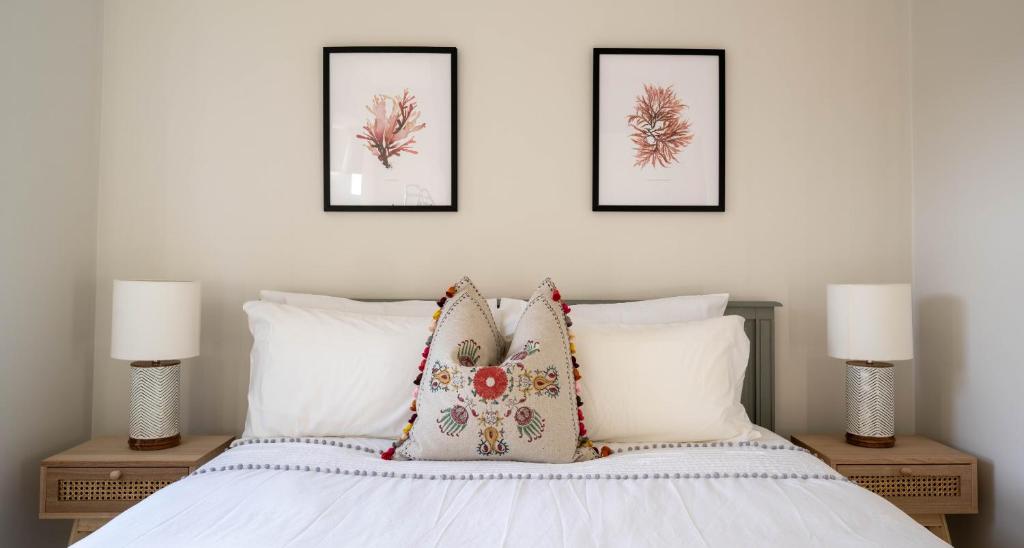 a bedroom with three pictures on the wall and a bed at 22 The Old Market in Yarm