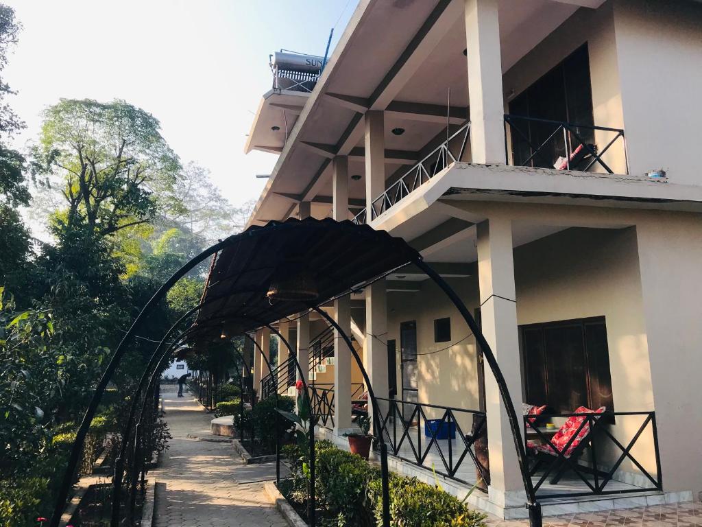 a building with an archway in front of it at BABA lodge & restaurant in Sauraha