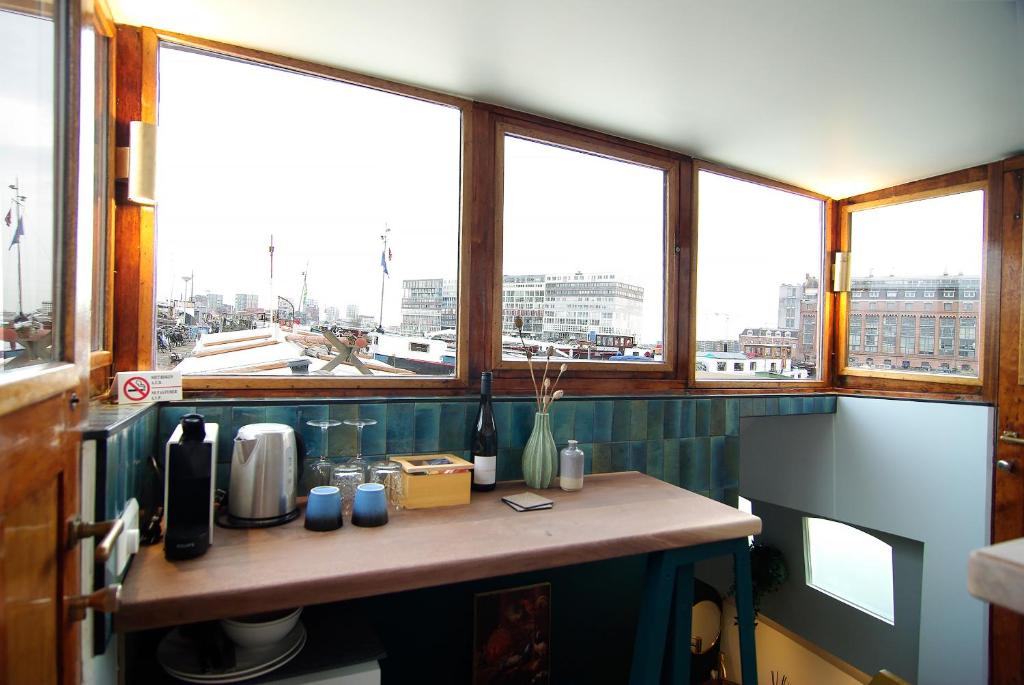 a kitchen with a counter with a view of a city at Najade Eco Houseboat in Amsterdam