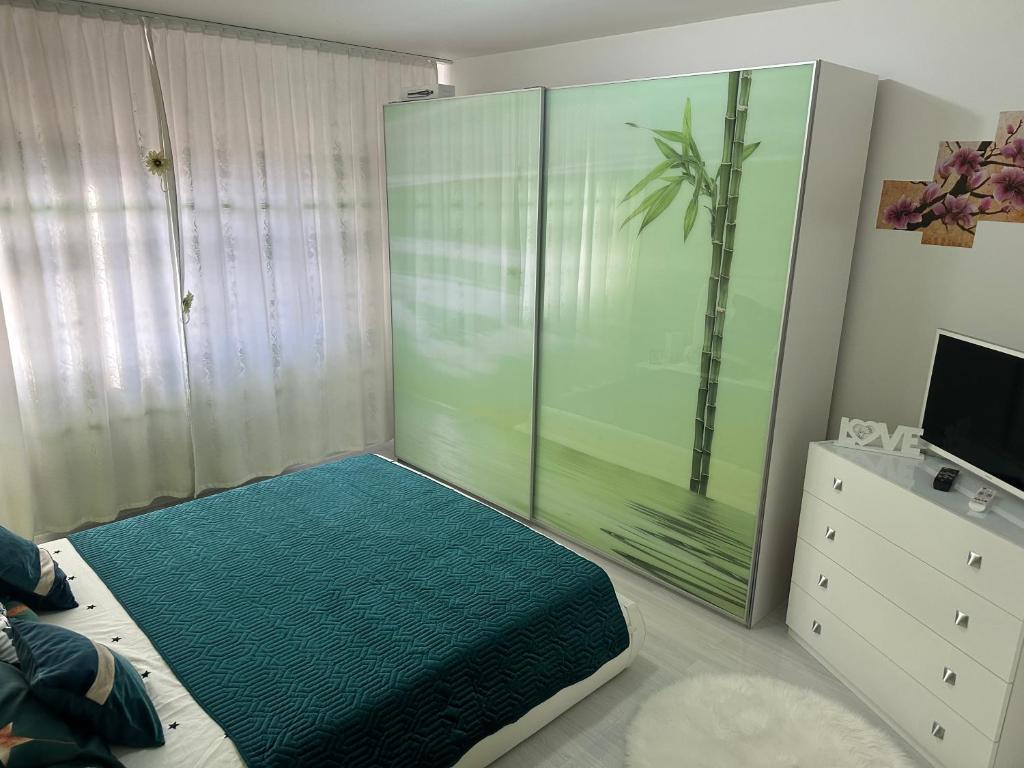 a bedroom with a large glass shower and a television at Inchisa in Deva