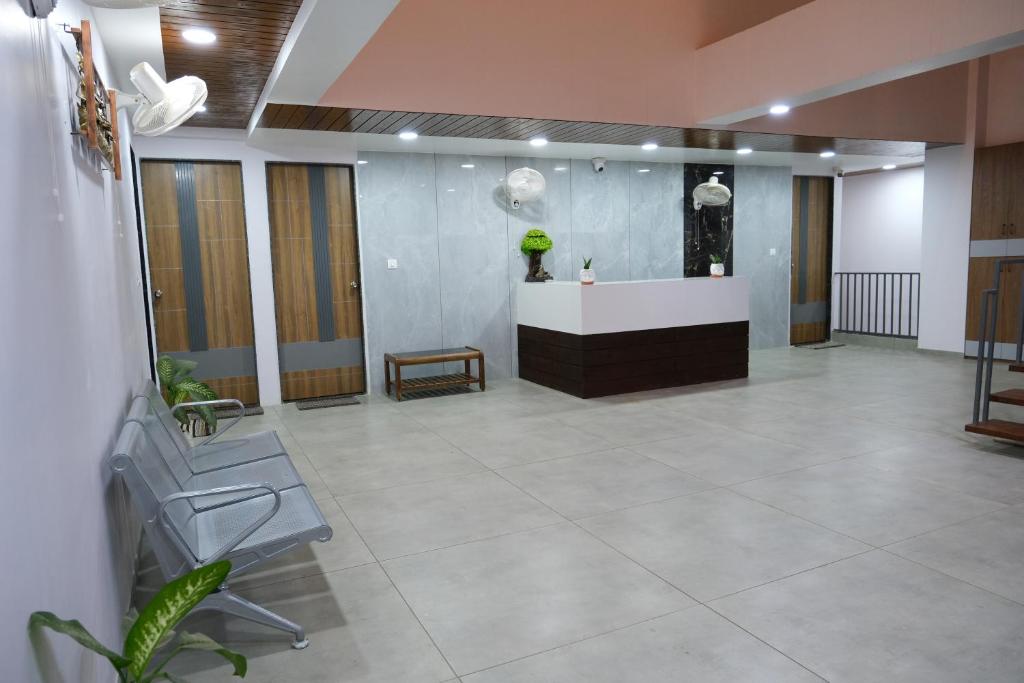 a lobby with a reception desk in a building at HOTEL SHREE RAM in Rājpīpla