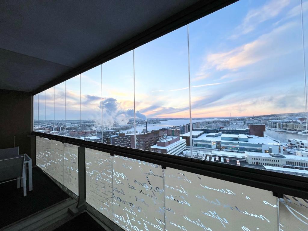 a view of a city from the balcony of a building at City Home Finland Panorama Suite - New Luxury Suite with Own SAUNA, One Bedroom, Spacious Balcony with City Views and Great Location next to Nokia Arena in Tampere