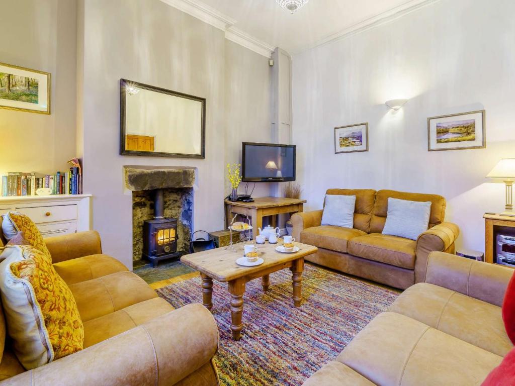 a living room with two couches and a fireplace at 3 Bed in Hawkshead Village LLH21 in Hawkshead