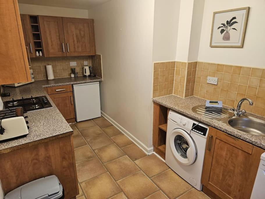 a kitchen with a washing machine and a sink at Betjiman Retreat Relaxtion Awaits in Gateshead