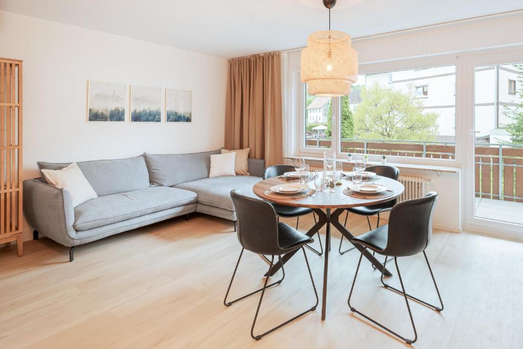 sala de estar con mesa y sofá en Ferienwohnung Sonnenglück mit großzügigem Südbalkon, en Lenzkirch