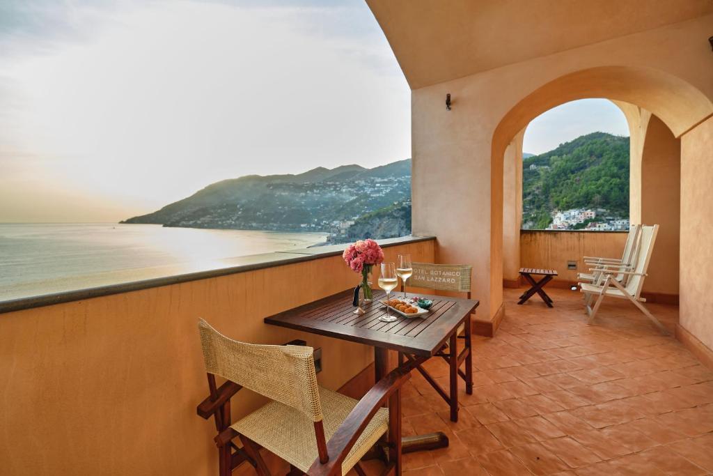 a dining room with a table and a view of the ocean at Hotel Botanico San Lazzaro in Maiori