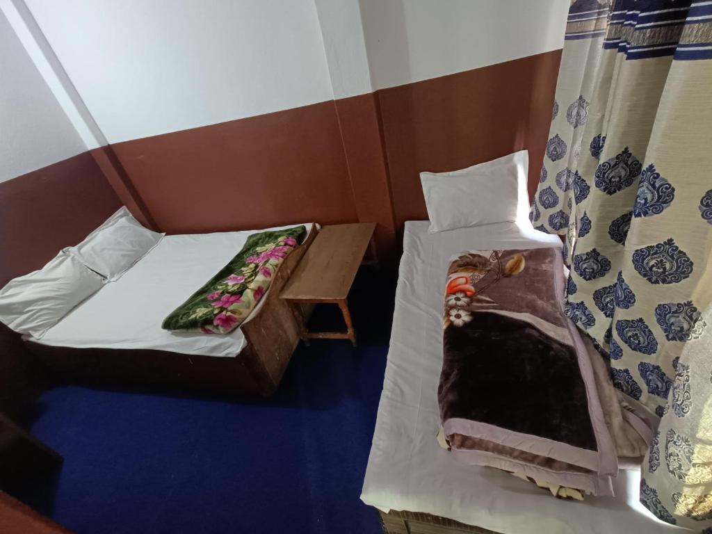 Postel nebo postele na pokoji v ubytování Hotel Sai Aman