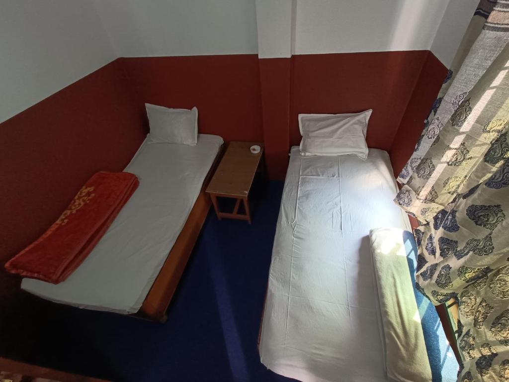 Postel nebo postele na pokoji v ubytování Hotel Sai Aman