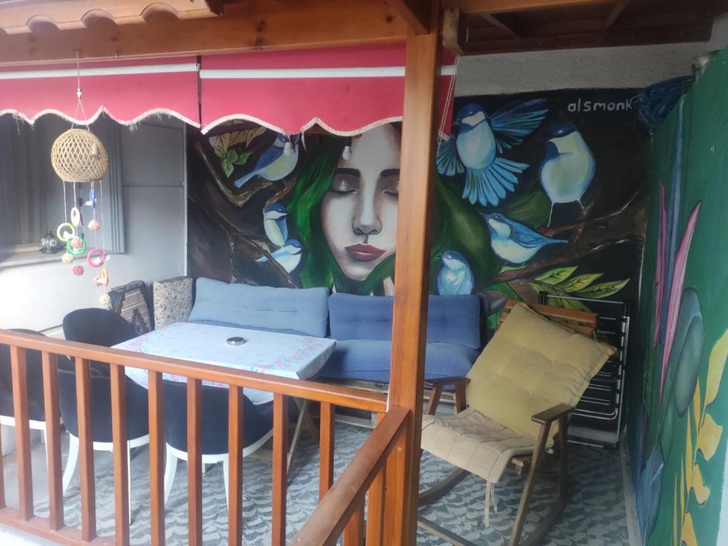 a mural on the side of a house with a table and chairs at LAVİNYA PENSİON in Kuşadası