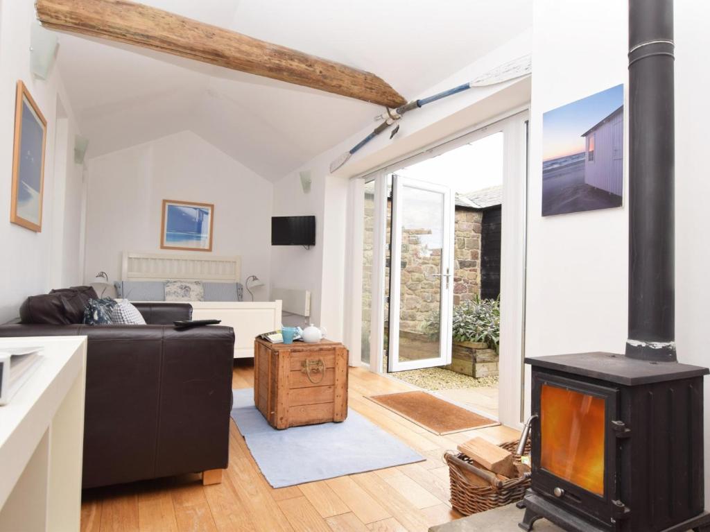 a living room with a wood stove in it at 1 Bed in Nr Bamburgh CN002 in Lucker