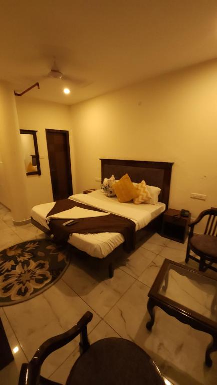 a hotel room with a bed and a chair at Hotel Velvet Horizon in Chandīgarh