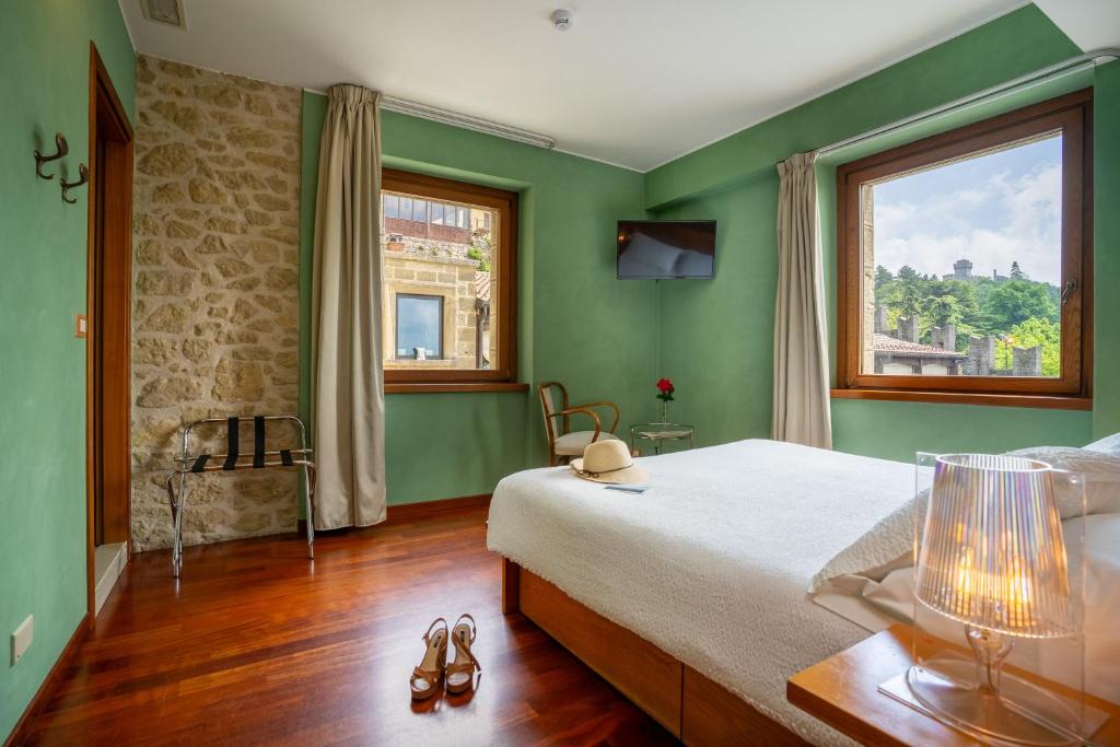 Postel nebo postele na pokoji v ubytování Hotel Cesare