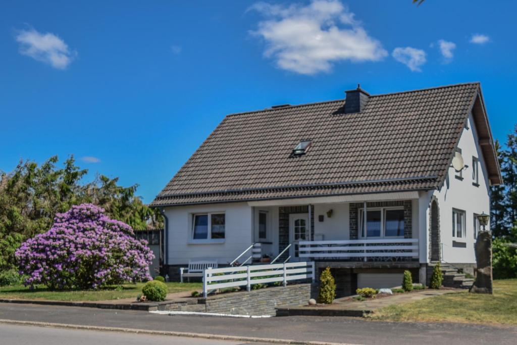 a white house with a gray roof at Ferienhaus Eifelwind Kamberg in Hellenthal