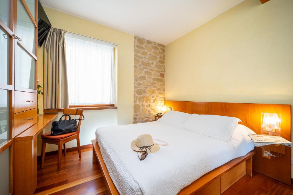 Postel nebo postele na pokoji v ubytování Hotel Cesare