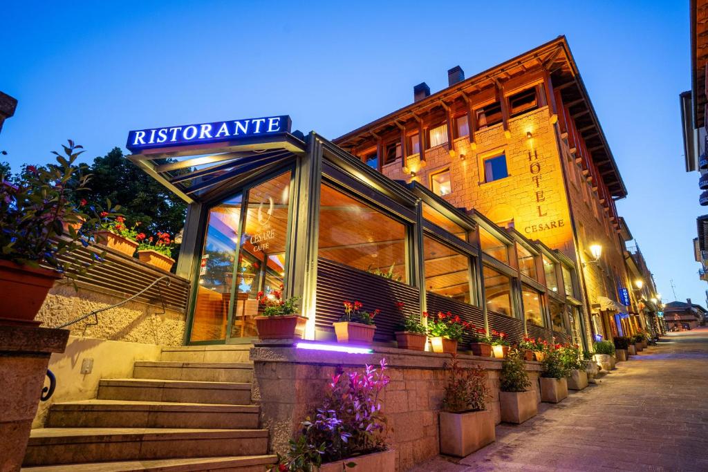 a building with a sign that reads riccartonamine at Hotel Cesare in San Marino