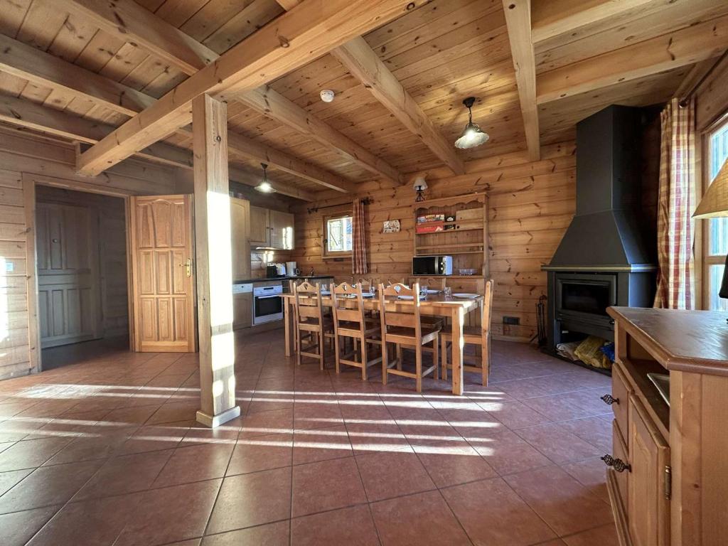 a kitchen with a table and chairs in a cabin at Chalet La Joue du Loup, 4 pièces, 8 personnes - FR-1-651-11 in Le Dévoluy