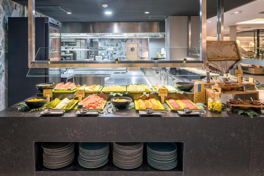 a buffet line with many different types of food at MYND Yaiza in Playa Blanca