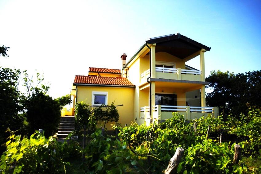 a yellow house with a red roof at Apartment Ursula in Lopar