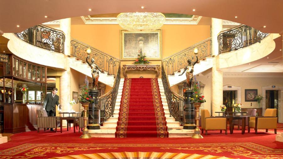 a staircase in a building with a red carpet at Bridge House Hotel, Leisure Club & Spa in Tullamore