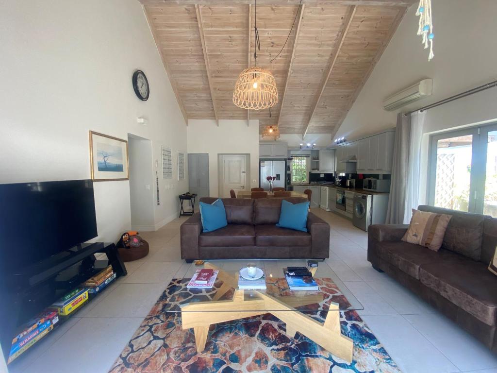 a living room with a couch and a coffee table at Leopard Tree Cottage in Franschhoek