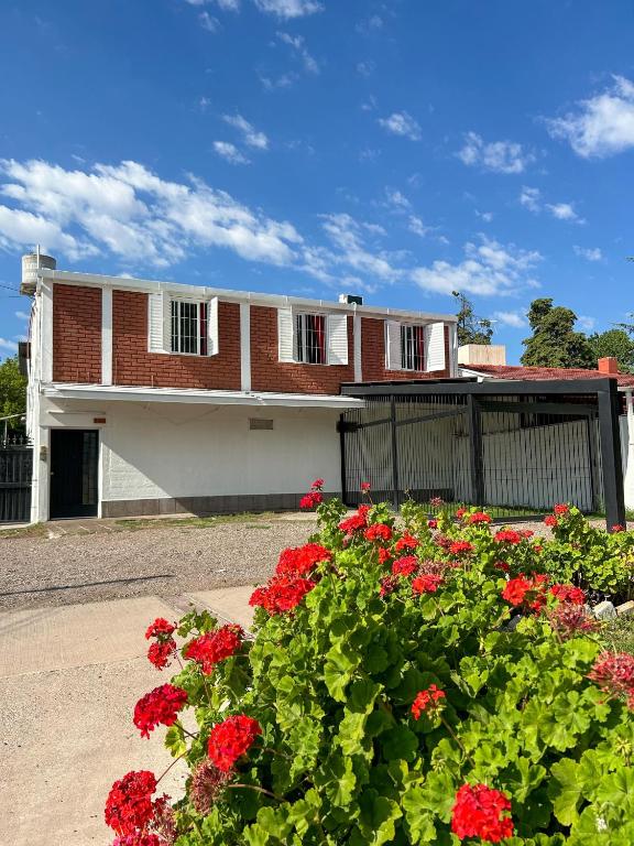 a house with red flowers in front of it at Almma Mia in Godoy Cruz