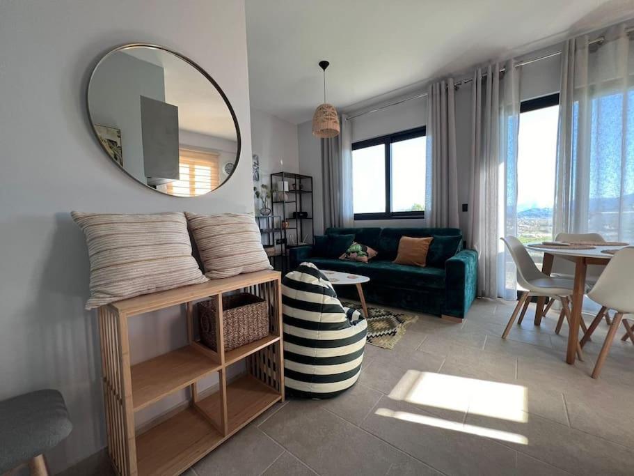 a living room with a mirror and a couch at Apartment Daria in Sarandë