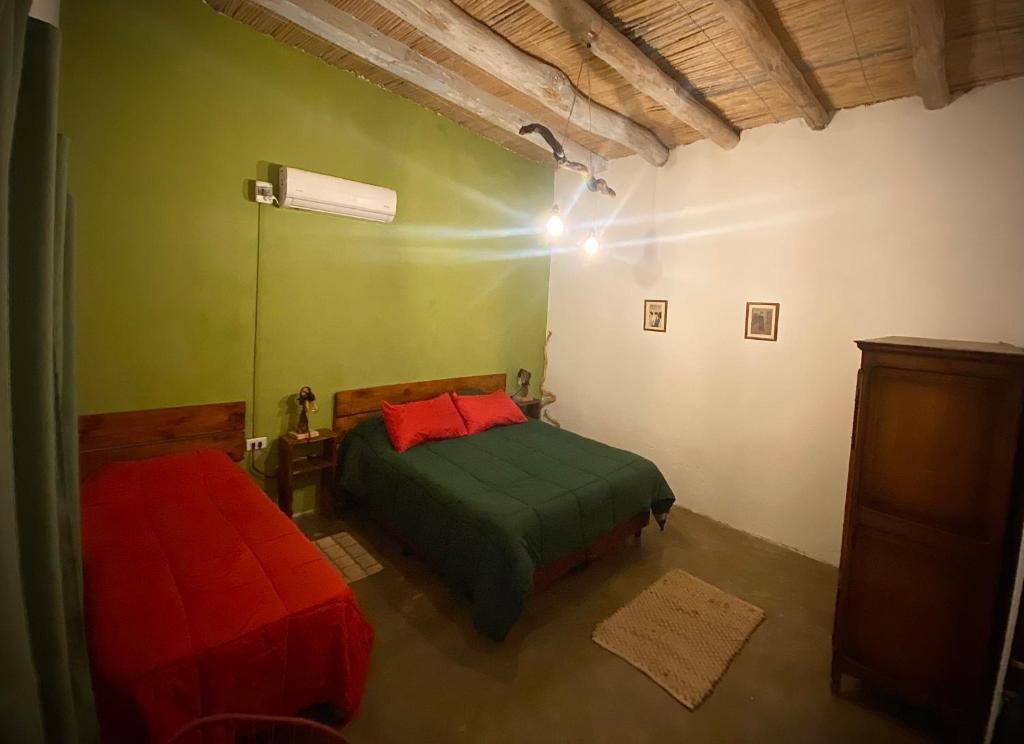 a bedroom with two beds in a room at El Cortijo Tinogasta in Tinogasta
