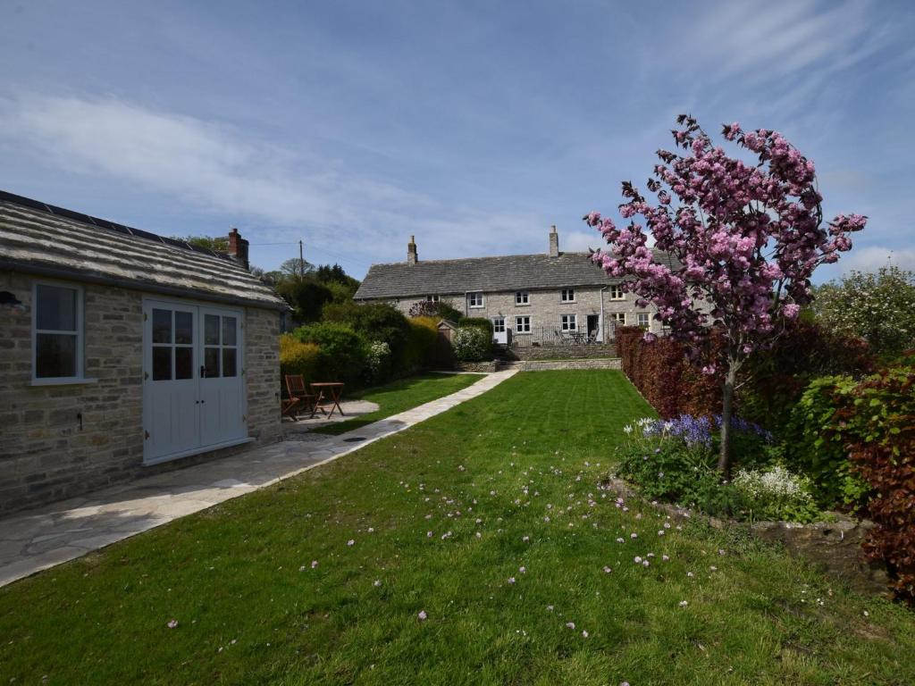a house with a garden and a yard with a tree at 3 Bed in Isle of Purbeck IC027 in Kingston