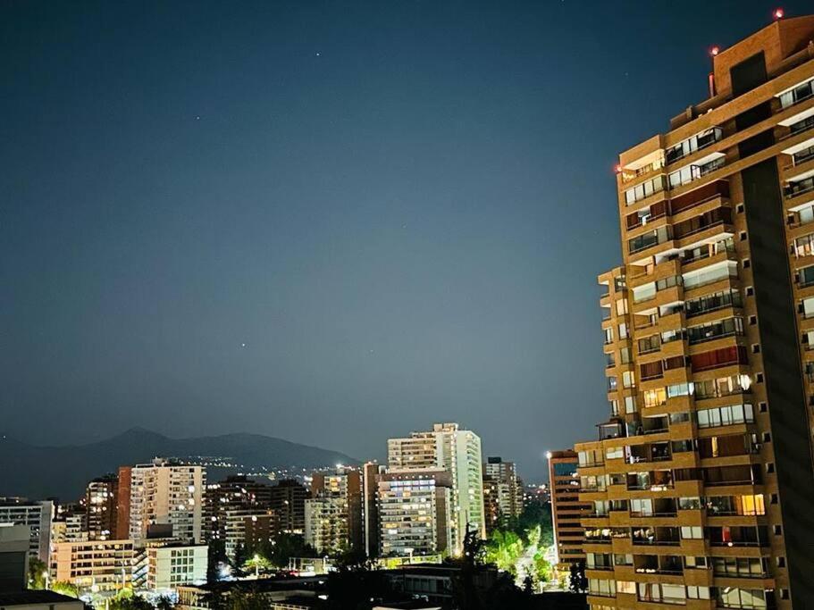 a view of a city with a tall building at Departamento en Las Condes in Santiago