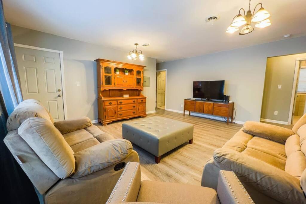 a living room with two couches and a flat screen tv at Large 6BR, 6 Bath in the city of Niagara Falls in Niagara Falls