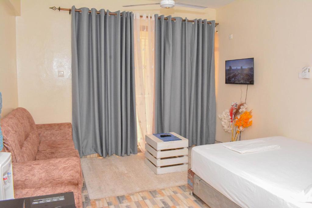 Llit o llits en una habitació de NIKO HOMES