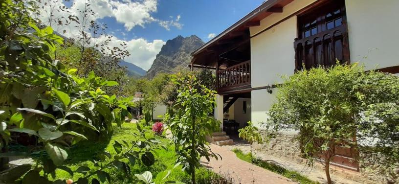 a house with a mountain in the background at Hotel Casablanca in Ollantaytambo