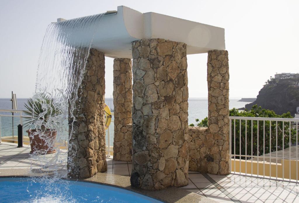 a water fountain in the middle of a pool at XQ El Palacete in Morro del Jable
